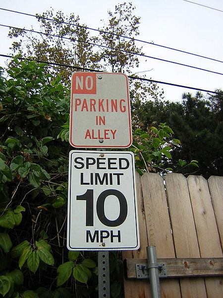 This photo shows the number 10 written on a speed limit sign.