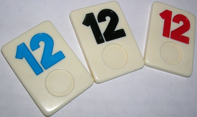 This photo shows the number 12 written on a set of Rummikub tiles.